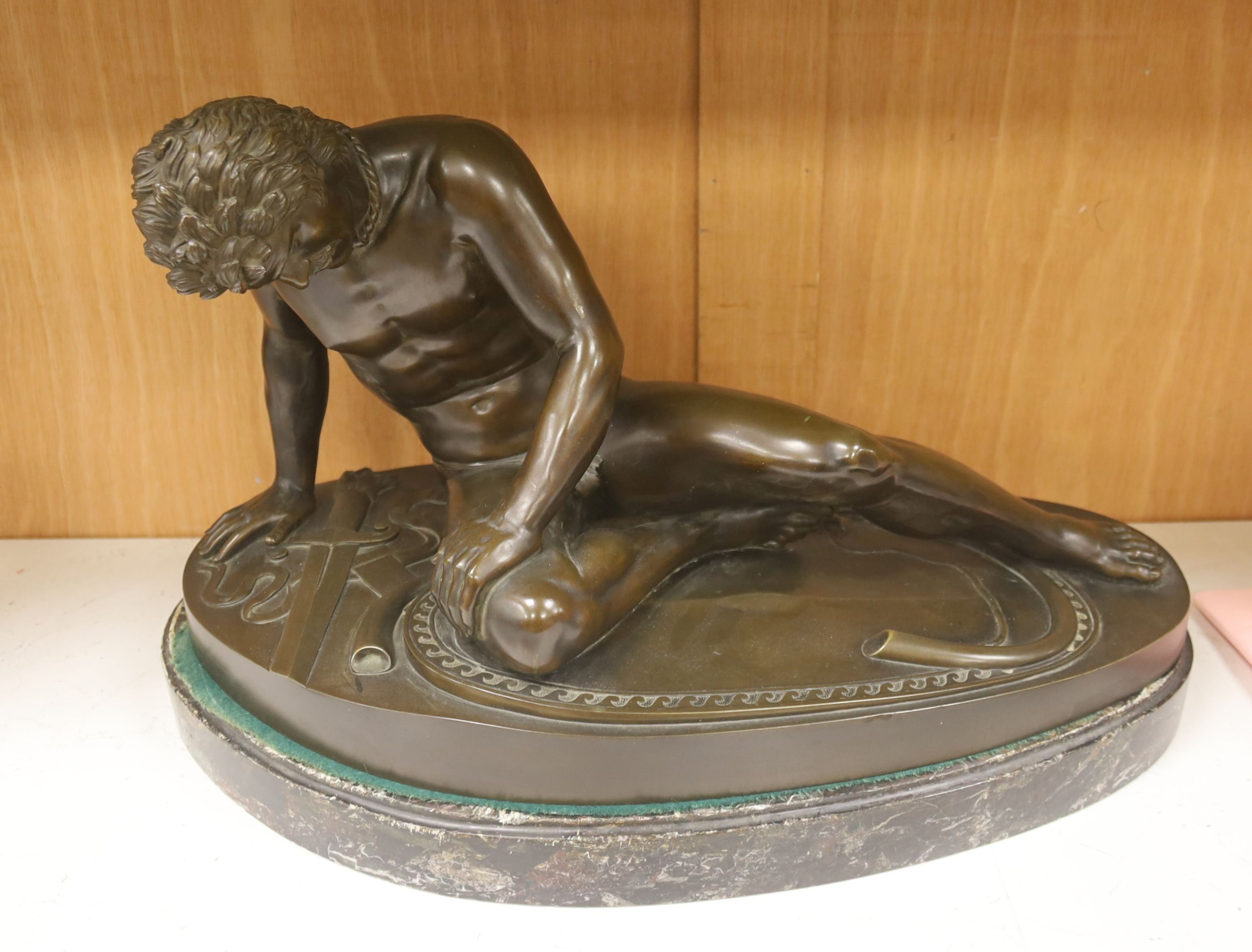 After the Antique, a large bronze figure of 'The Dying Gaul', on a marble plinth, length 55cm